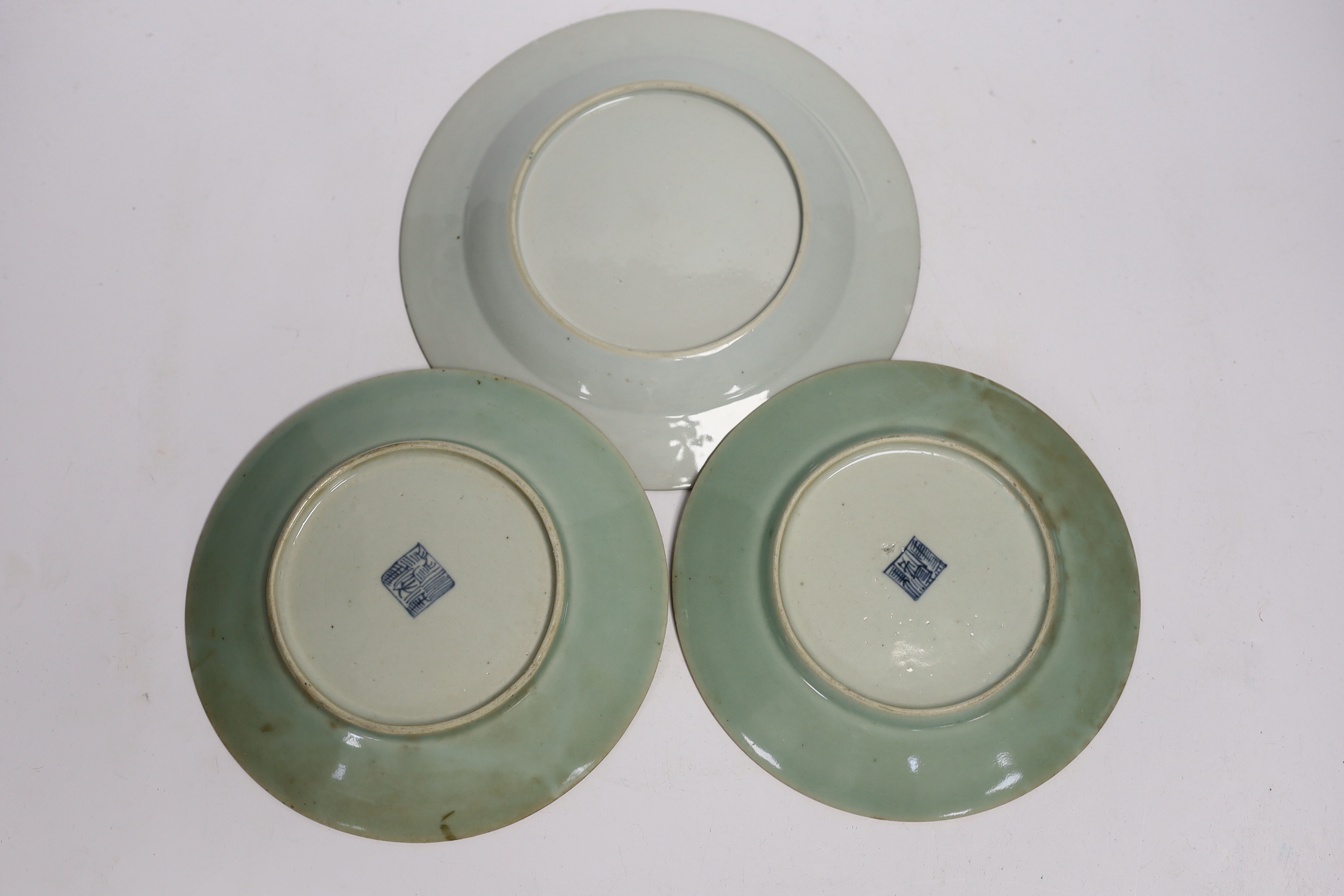 An 18th century Chinese export famille rose plate, 23cm diameter, and two 19th century celadon famille rose plates